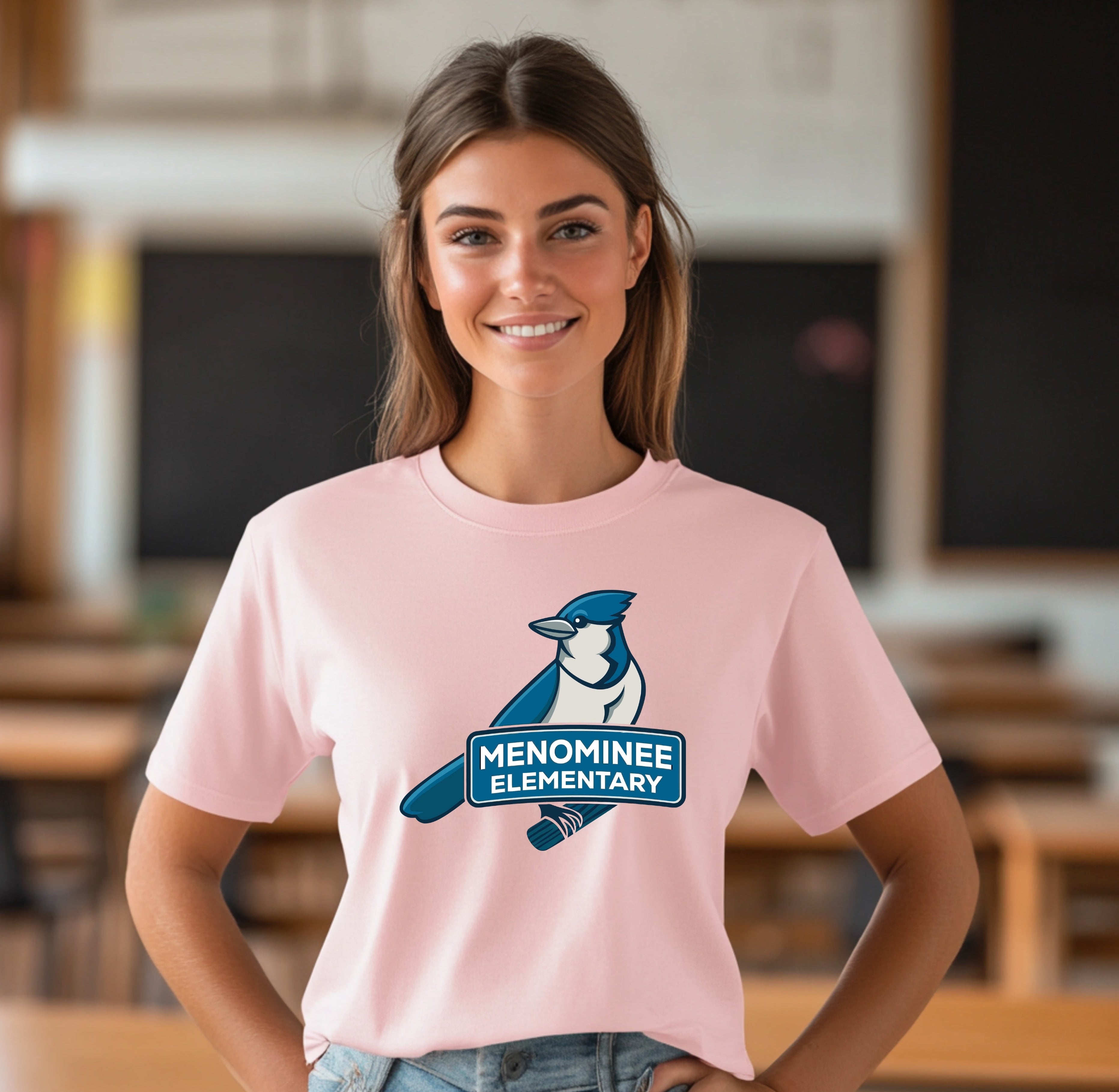 Person wearing a pink t-shirt with a logo in an indoor setting